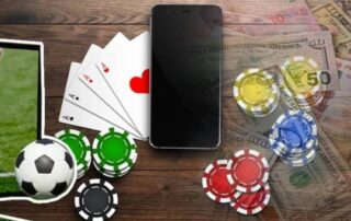 A mobile phone surrounded by poker chips, playing cards, and sports betting elements symbolizing wagering requirements