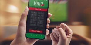 Close-up of a mobile screen showing a winning sports bet with clenched fist celebrating.