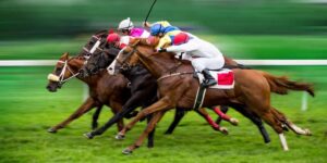 Close finish in a horse race with jockeys pushing hard, symbolising features that support exotic betting strategy.