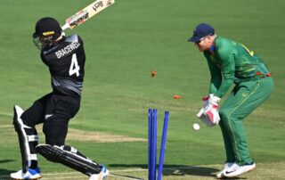 Batsman bowled out as stumps are shattered during a professional cricket match, action moment relevant to cricket betting markets