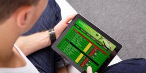 Man viewing cricket betting markets and odds on a tablet device