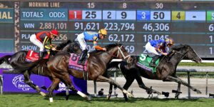 Market-based modelling in Australian racing shown through racehorses competing in front of a live odds and betting totals board.